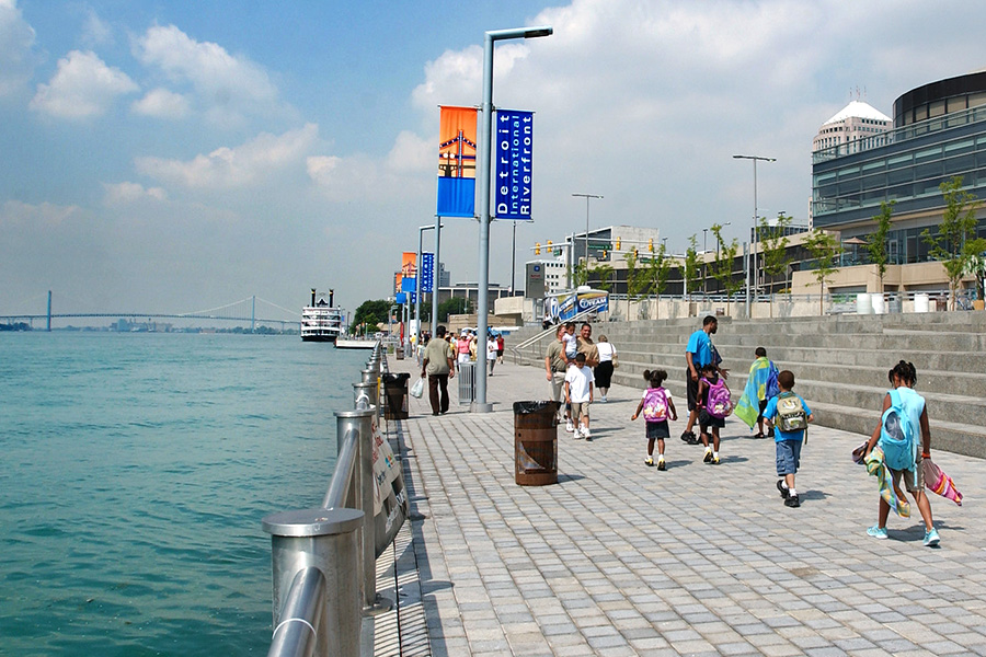 Detroit International Riverwalk pictured with pedestrians.